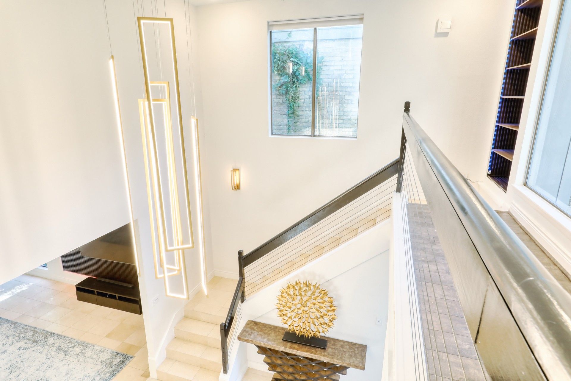 Modern staircase with sculptural pendant lighting