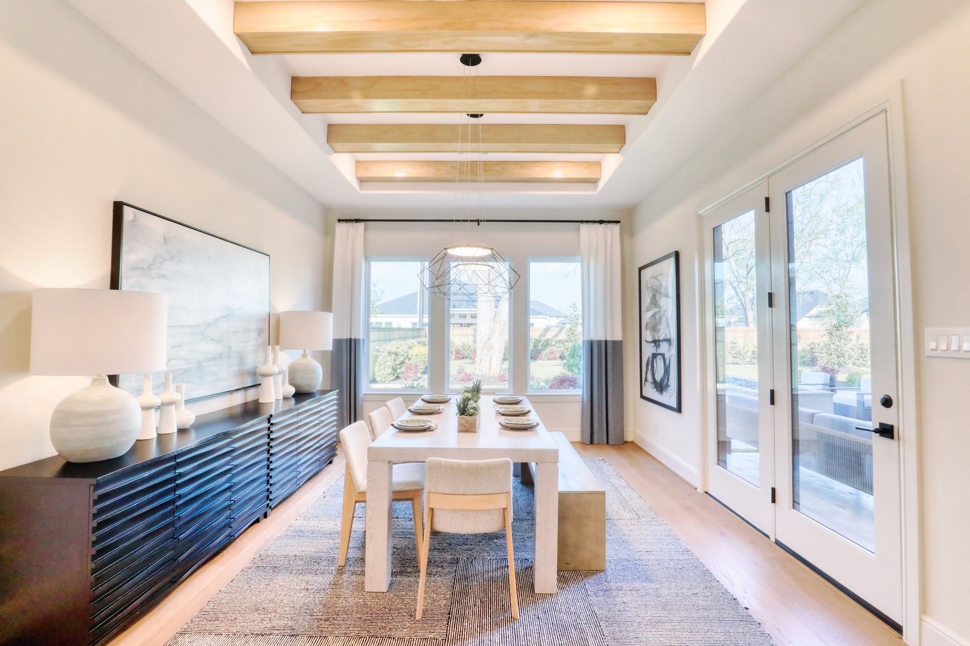 Dining room with wood-beam ceiling and French doors
