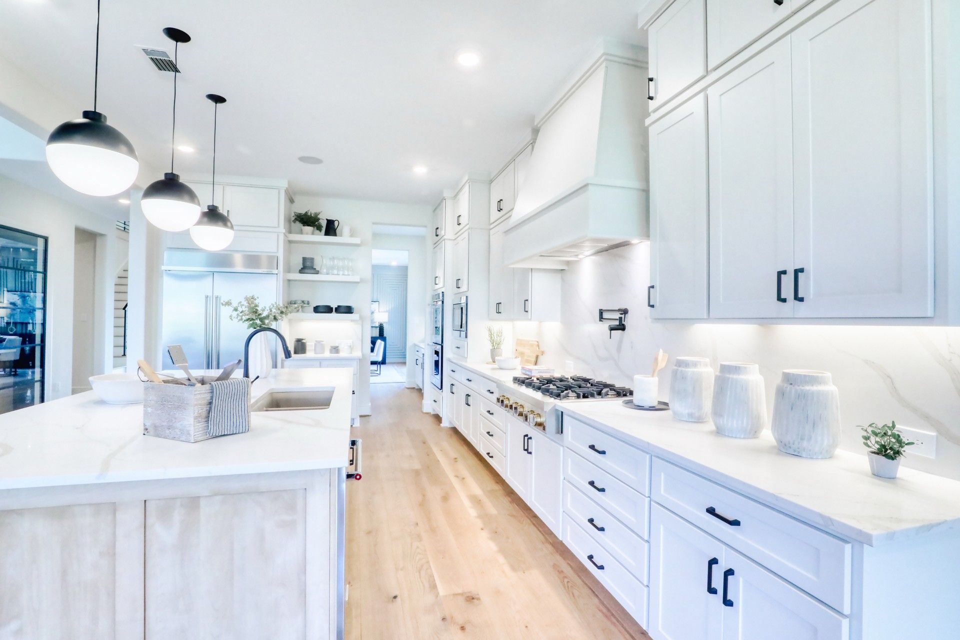 Bright white kitchen with globe pendant lights