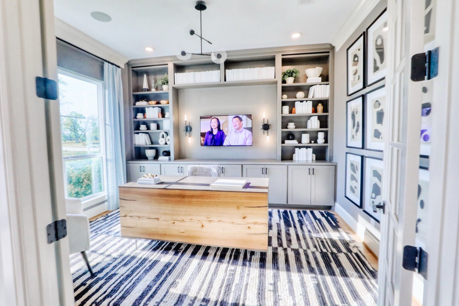 Home office with built-in shelves and gallery wall